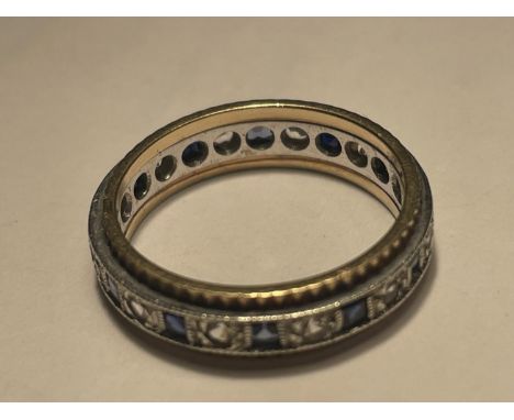 A 9 CARAT GOLD RING WITH A BAND OF SAPPHIRES AND CUBIC ZIRCONIA STONES 