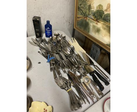 A LARGE QUANTITY OF FLATWARE TO INCLUDE KNIVES, FORKS, SPOONS, PLUS SILVER POLISH 