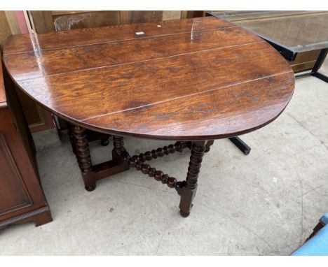 A GEORGIAN STYLE OAK GATE LEG TABLE DINING TABLE ON BOBBIN TURNED LEGS AND STRETCHERS 59" X 48" OPENED 