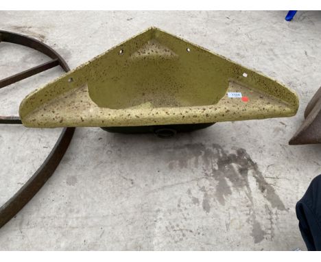 A CAST IRON CORNER FEED TROUGH PLANTER 