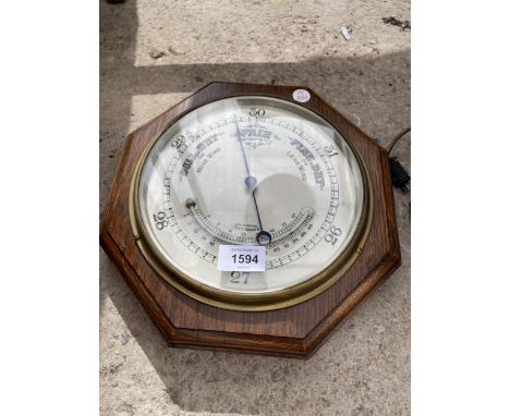 A VINTAGE OCTAGONAL WOODEN CASED BAROMETER 