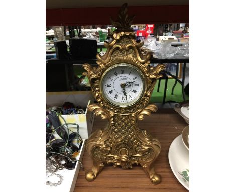 A LARGE GILT COLOURED JULIANA MANTLE CLOCK WITH ELABORATE DECORATION HEIGHT 46CM 