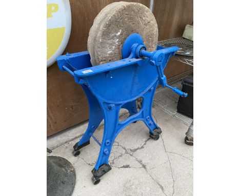 A VINTAGE SANDSTONE GRIND STONE WITH CAST IRON BASE 