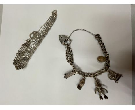 TWO SILVER BRACELETS TO INCLUDE A CHARM BRACELET WITH FIVE CHARMS AND A FIVE BAR GATE BRACELET 