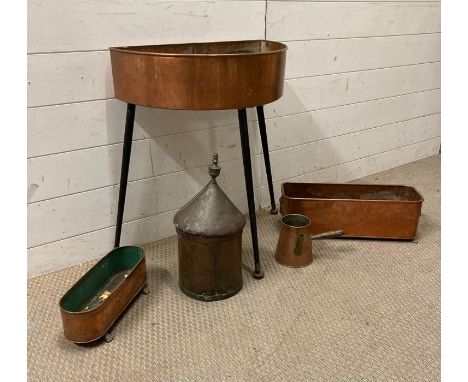 A selection of vintage copper items to include a planter on tripod legs, two window planters on lion feet and a copper pot 