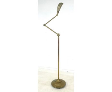 An early 20th century brass standard lamp, with articulated arm and shell shaped shade, 28 by 100cm high, together with a tur