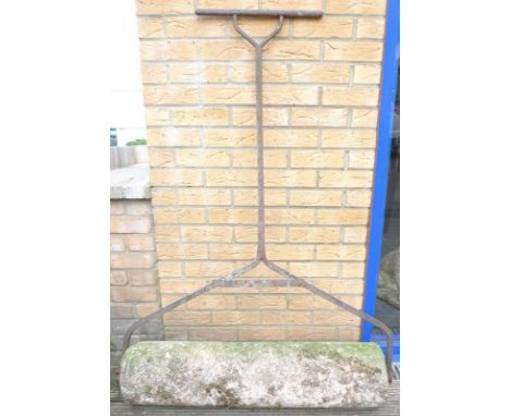 A 19th century garden roller, with stone cylinder and iron frame and handle, 110 by 21 by 145cm high.