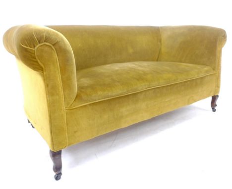 A Chesterfield sofa, early 20th century, upholstered in gold dralon, raised on short cabriole shaped legs and castors, 162 by