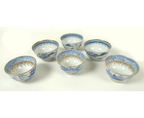 A group of three mid 18th century porcelain tea bowls, possibly Worcester, decorated in underglaze blue with Chinese river sc
