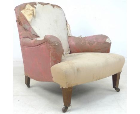 An Edwardian low easy armchair, in the style of Howard & Sons, partly upholstered in pink foliate satin and white calico bene