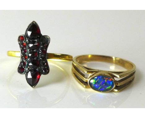 A 22ct gold ring with later applied garnet decoration, band hallmarked, size K but mis-shapen, 3.1g, together with a 9ct gold