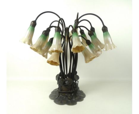 A Tiffany style lamp, late 20th century, formed as a plethora of lilies with bronzed lily pads base, with eighteen green and 