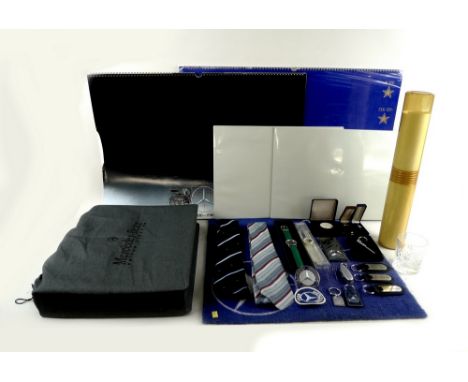 A large collection of Mercedes Benz memorabilia, including a briefcase, a set of bottle-stoppers designed as gear sticks, sev