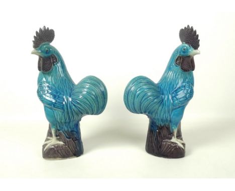 A pair of modern Chinese turquoise glazed ceramic figurines, modelled as cockerels, 28cm. (2)