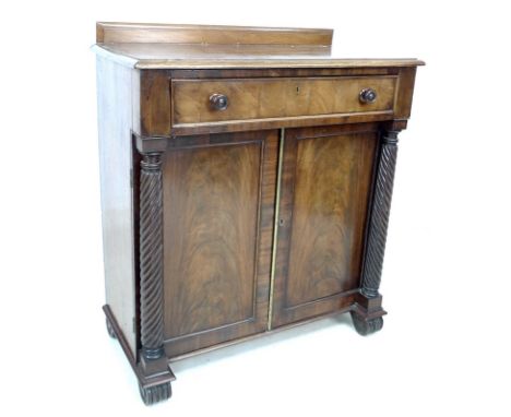 An early 19th century mahogany chiffonier, with fitted secretaire drawer, spiral turned columns flanking double doors with br