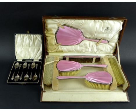 A George VI silver and enamel backed dressing table set comprising hand mirror, hair brush, two clothes brushes and comb, all