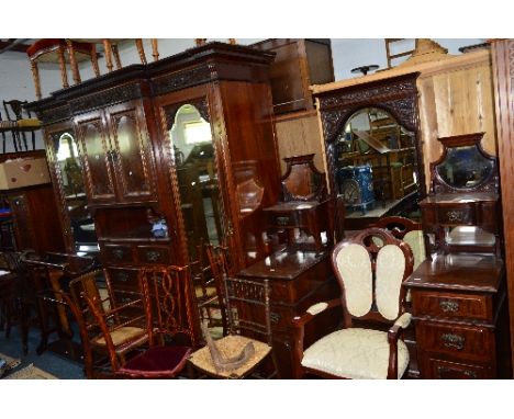 AN EDWARDIAN FLAME MAHOGANY TWO PIECE BEDROOM SUITE, comprising of a compactum wardrobe with double bevelled edge mirror door