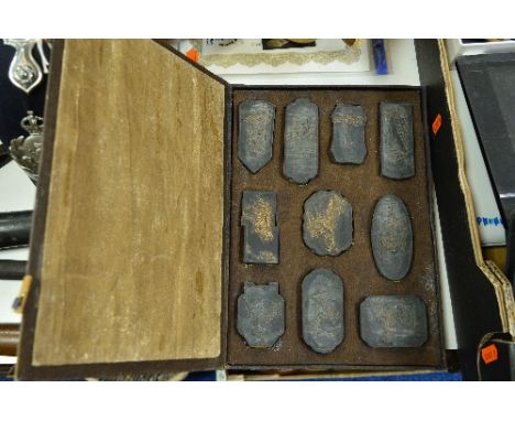 A CASE OF BLACK AND GILT MOULDED CERAMIC CHINESE DECORATIVE TILES 