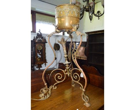 A 20TH CENTURY BRASS PLANT STAND, on triple scrolled legs united by a central finial