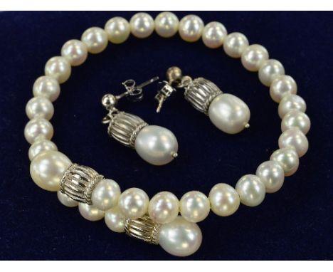 A FRESH WATER PEARL TORQUE BANGLE AND MATCHING EARRINGS