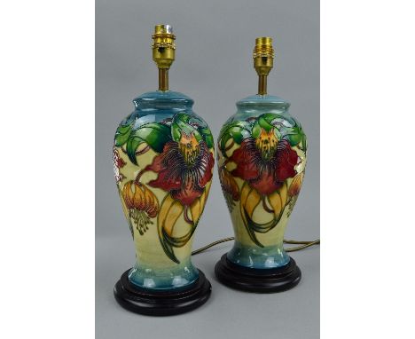 A PAIR OF MOORCROFT ANNA LILY TABLE LAMPS, of baluster form, designed by Nicola Slaney, both mounted on wooden circular bases