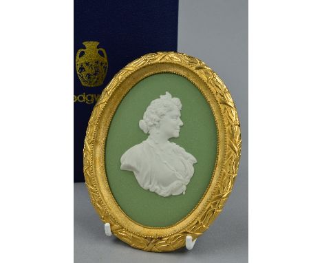 A BOXED LIMITED EDITION WEDGWOOD PORTRAIT MEDALLION, in white on sage green jasper in an ormolu frame, to commemorate HM Quee
