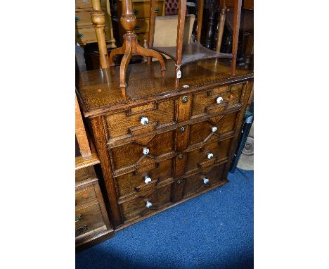 AN EARLY 20TH CENTURY OAK GEOMETRIC STYLE CHEST, of four long graduating drawers with replacement ceramic handles, approximat