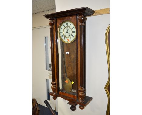 A VICTORIAN WALNUT VIENNA WALL CLOCK, 8 day movement, circular enamel dial with Roman numerals, approximate size height 97cm 