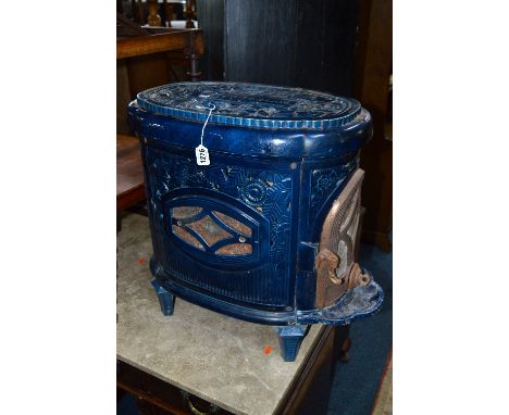 AN EARLY 20TH CENTURY FRENCH OVAL BLUE ENAMEL STOVE, with opening door to narrowest end, pierced leaf detail to the side and 