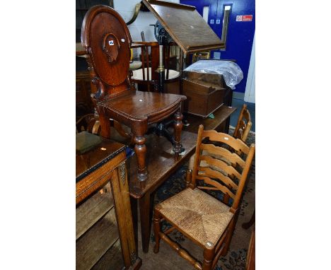 AN EARLY 20TH CENTURY CARVED OAK HALL CHAIR, and two rush seated ladder back chairs (3)