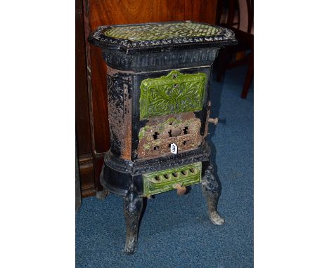 A VICTORIAN BLACK AND GREEN ENAMEL FRENCH STYLE STOVE, with pierced detail and various opening flaps, raised on legs, approxi