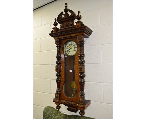 A VICTORIAN WALNUT VIENNA REGULATOR WALL CLOCK, 8 day movement, the circular enamel dial with Roman numerals, turned uprights