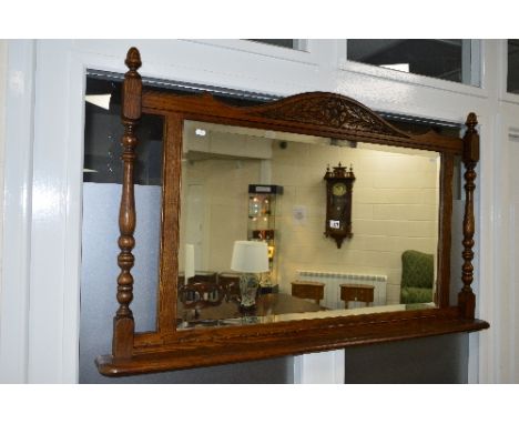 AN OLD CHARM OAK OVERMANTLE MIRROR, with bevelled edging and shelf under, approximate size width 137cm x height 79cm