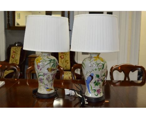 A PAIR OF MODERN CERAMIC TABLE LAMPS, with birds and fruiting vine detail, with shades