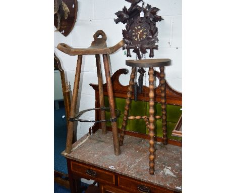 A CARVED OAK THREE LEGGED BAR STOOL, and another three legged stool (2)