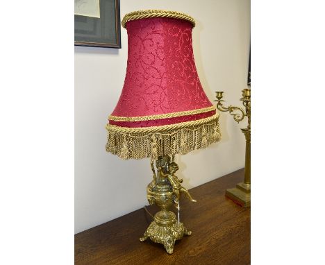 A VICTORIAN STYLE FIGURAL BRASS TABLE LAMP, cast with twin handles and a putti with a shade