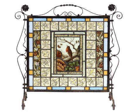 ARTS & CRAFTS STAIN GLASS FIRESCREEN an ornate stain glass firescreen, the central panel with a Robin perched on a tree branc