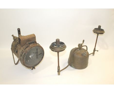 TWO TILLEY LAMPS including a hanging version with a metal bracket for support, and a large double ended tilley lamp. These ar