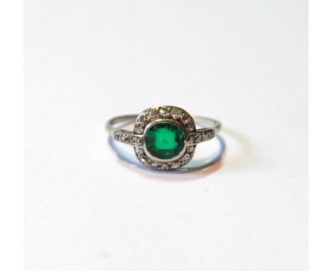 Diamond and emerald cluster ring with circular collet, eight-cut brilliants, size O½.CONDITION REPORT: Very scratched, natura