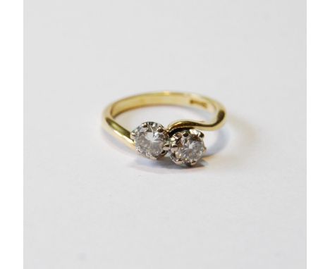 Diamond crossover ring with two brilliants, each approximately .3ct, in gold, '18ct', size G.CONDITION REPORT: Weight 2.8g.  