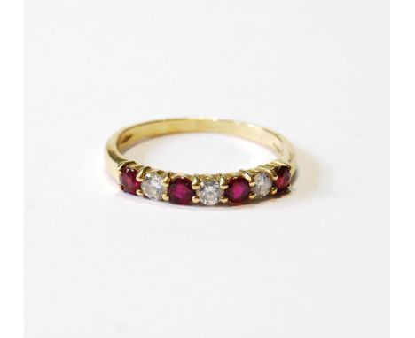 Eternity ring with four rubies and three diamond brilliants, in 18ct gold, size R.CONDITION REPORT: Good condition.  Little w