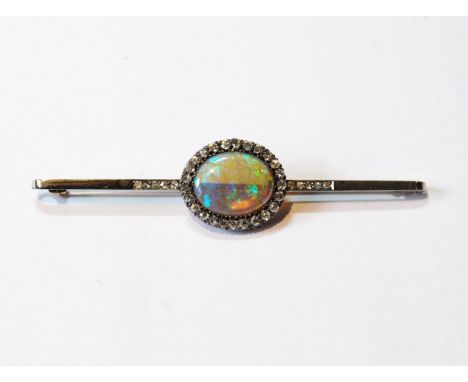 Victorian bar brooch with oval black/water opal surrounded and flanked by diamond brilliants in gold fronted with silver, siz