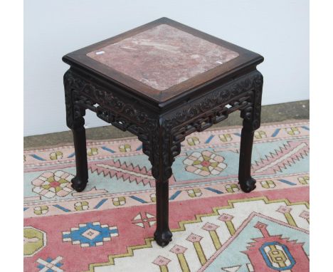 Oriental hardwood and marble jardinière stand, the moulded square top with marble inset panel over floral frieze, scroll open
