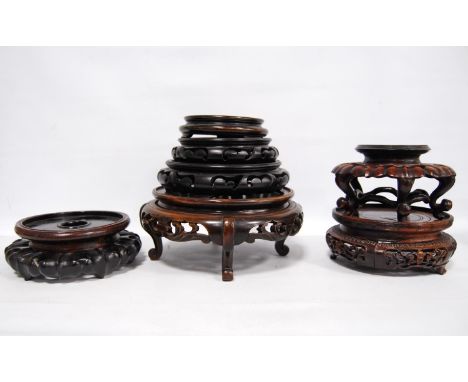 Eight oriental carved wooden stands.CONDITION REPORT: All are stands (not lids).  The stand with the elaborate fretwork is la