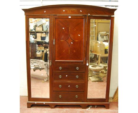 Edwardian mahogany and inlaid wardrobe, the arched projected cornice over quarter veneered and bluebell inlaid door, boxwood 