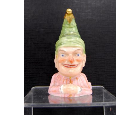 Victorian Royal Worcester novelty candle snuffer modelled as Mr Punch, designed by James Hadley, wearing a green hat with gil