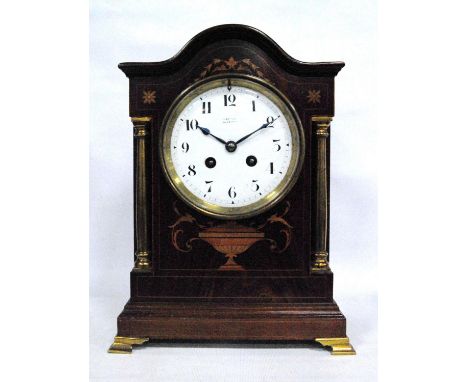 Mahogany and inlaid mantel clock by J Bryson, Edinburgh, the arched pediment over circular white enamelled face, Arabic numer