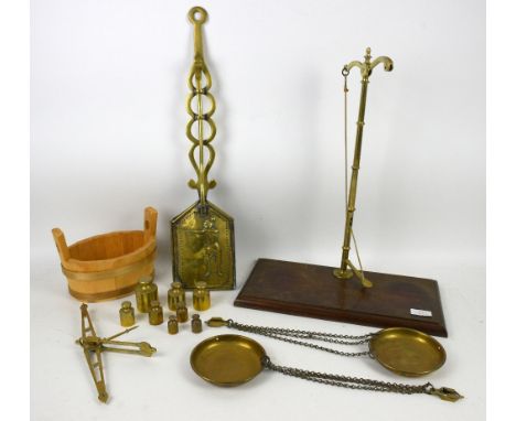 19th century brass fireside item embossed with archer and a set of scales 