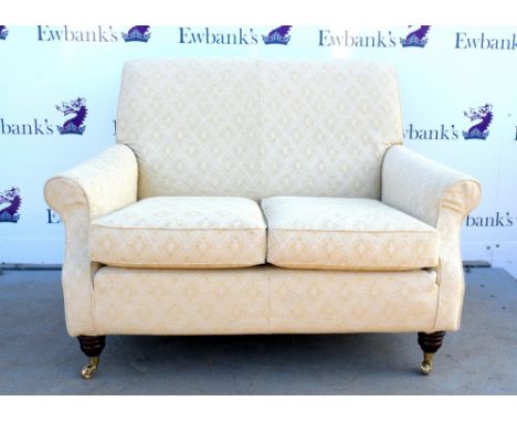 19th century style two seater sofa in cream, on mahogany legs to castors