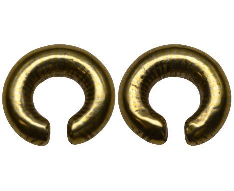 Celtic gold so-called ring-money, in the form of a plain penannular ring with traces of bands in alternate metallic colours, 